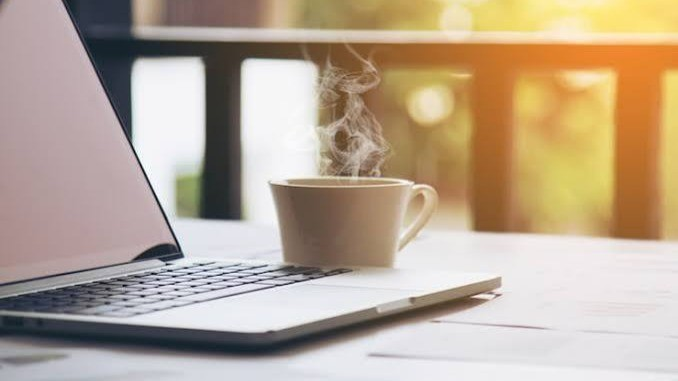 An image of a laptop and an cup of coffee